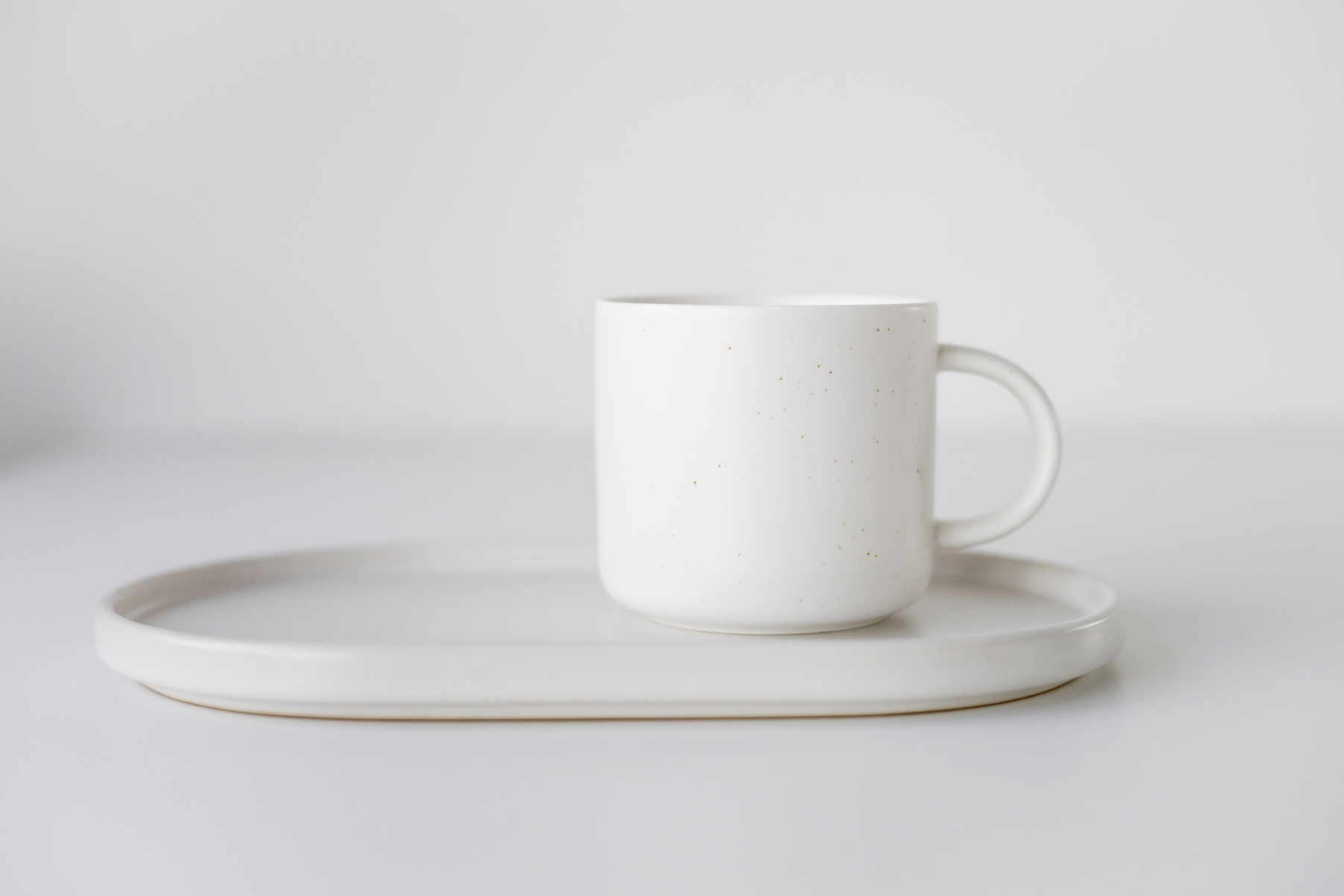 White Ceramic Mug on White Ceramic Plate